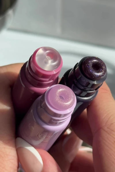 Laneige applying Glaze Craze Tinted Lip Serum in ROSE JAM (MUTED PINK) and LAVENDER FROSTING (COOL LAVENDER) and BLACK PLUM GLAZE (SHEER BLACK)