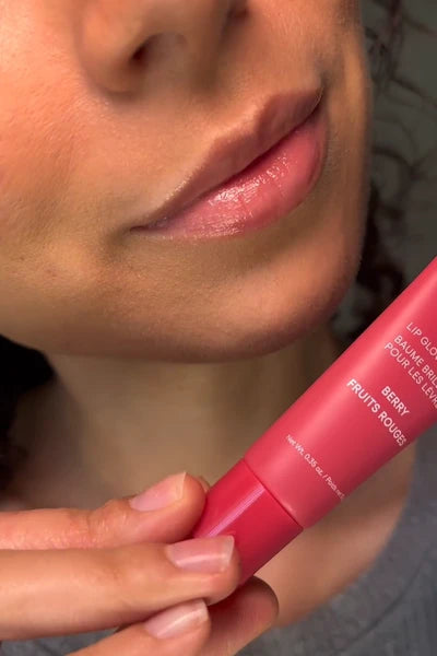 Melina applying Lip Glowy Balm in Berry (Pink tint)